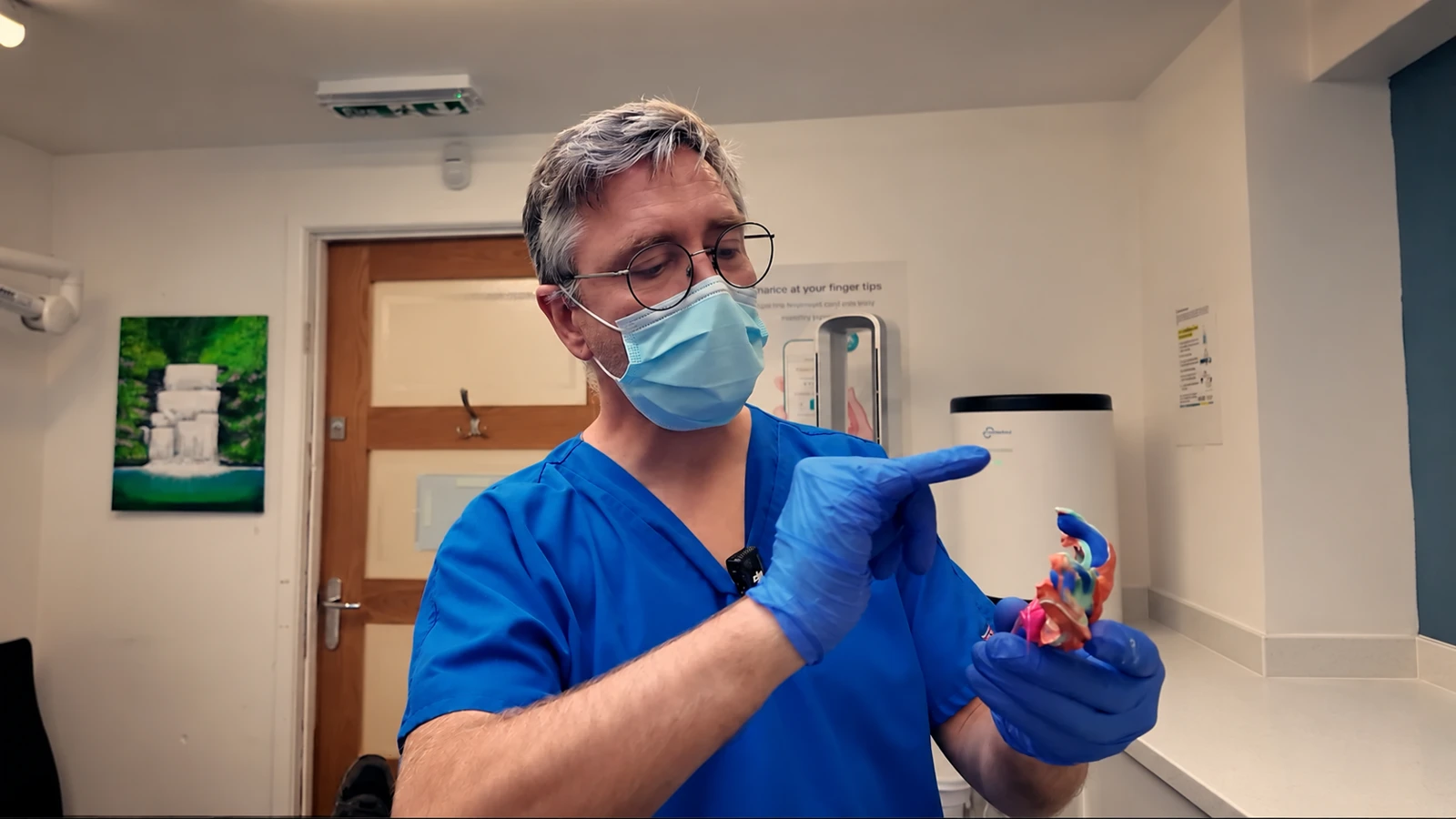 Simon using a denture model to explain treatment in the clinic